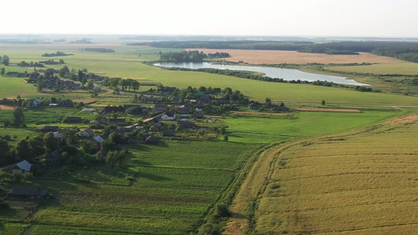 Top View of the Lake and the Village in the Field Before Sunset