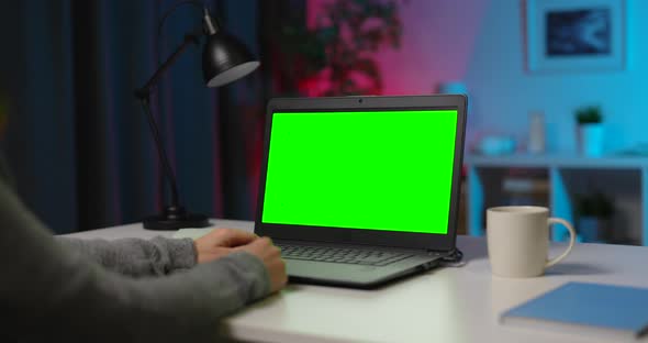 Woman Using Laptop with Green Screen