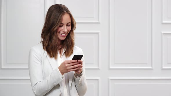 Businesswoman Texting on Smartphone