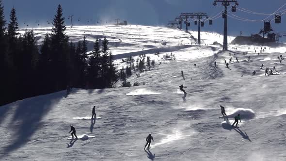 Skiers on a Ski Slope in Sunny Weather