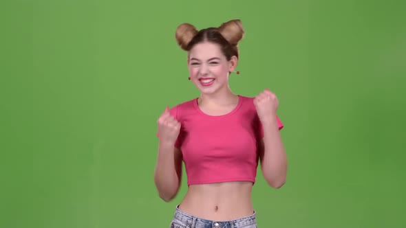 Teenage Girl in a Pink Top Is Delighted with the Victory alt