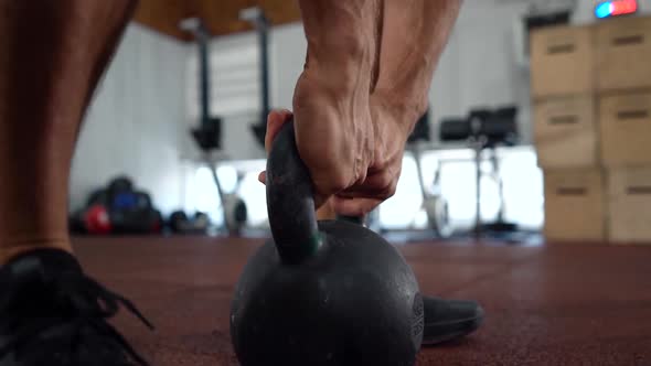 Kettlebell  crossfit training in gym. Young athlete getting ready for crossfit training  alt