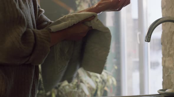 Woman Is Wiping Hands With Towel alt