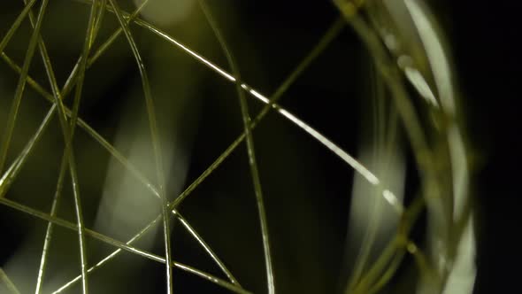 Golden Wireframe Sphere Object Spinning Into Focus alt