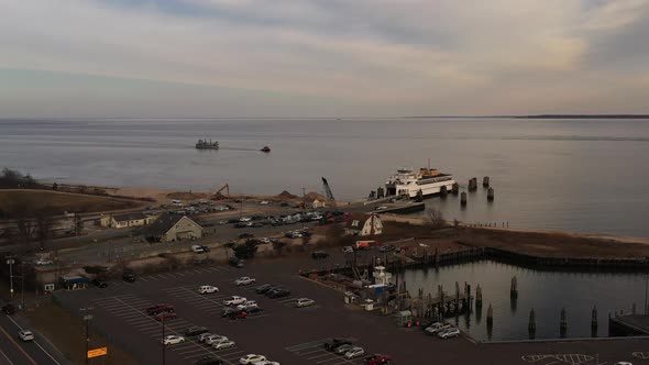 an aerial shot of the Orient Point ferry docked, taking on vehicles and passengers. It was a cloudy alt