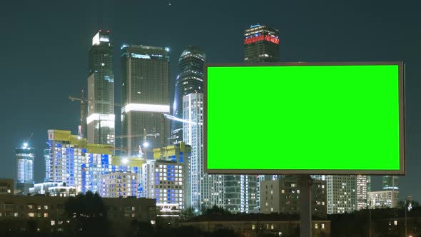 Green Screen Billboard on a Megapolis with Neon Lights, Skyscrapers on Background alt