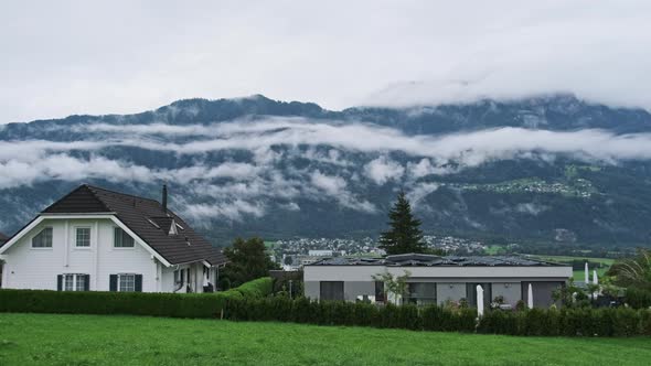 Panoramic View Liechtenstein with Houses on Green Hills in Cloudy Alps Mountain alt