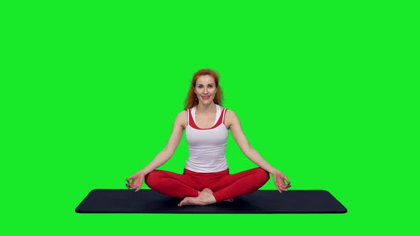 Beautiful Woman Sitting In Meditation Lotus Pose On Mat During Yoga, Chroma Key