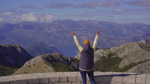 A Young Woman Traveler Visits the View Point on the Top of the Lovcen Mountain alt