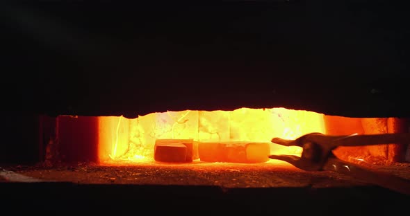Closeup Manual Unloading Hot Metal From Furnace alt