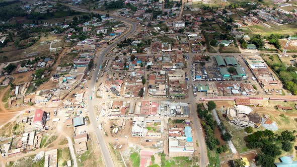 Rural settlement Africa- Aerial flyover poor Kibera Slum and modern skyline of Nairobi in background alt