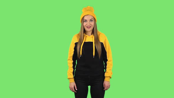 Modern Girl in Yellow Hat in Anticipation of Worries, Then Smiling and Proud of Himself. Green alt