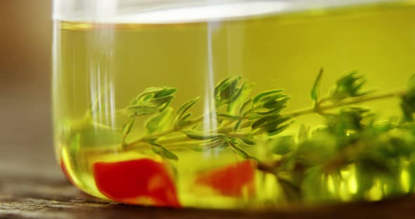 Red pepper pieces and rosemary in olive oil alt