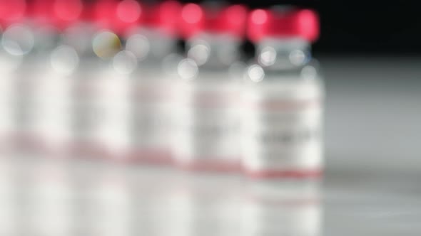 Covid19 Coronavirus Vaccine Vial on the Table Coming Into Focus alt