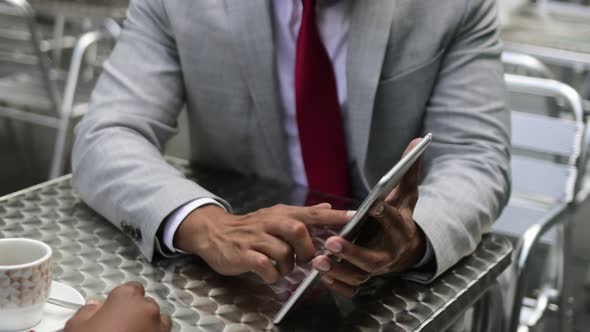 Cropped Shot of Young Businessman Using Tablet alt