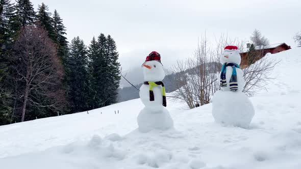 Winter Spirit  Two Snowman with Hat and Scarf Over Mountain alt