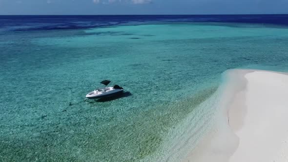 Aerial Drone Video of Boat Anchored in Tropical Exotic Island Bay with Crystal Clear Turquoise Sea