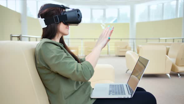 Side View Woman Enjoying Modern Vr Technology Using 3D Virtual Reality Headset and Laptop alt