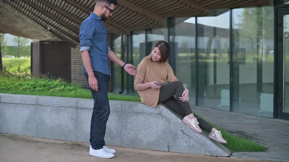 Meeting of two young people - a man and a woman in the park alt