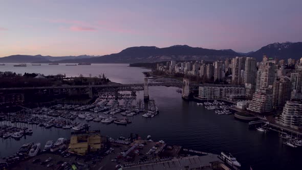 Burrard Bridge and cityscape at sunset, Vancouver district, British Columbia in Canada. Aerial panor alt