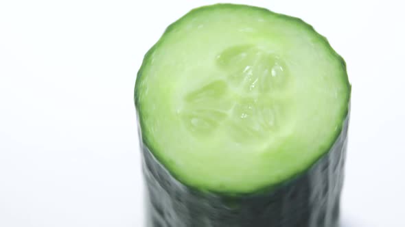 Rotating Cucumber on a White Background a Slice of Green Fresh Cucumber