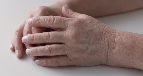 Hands of an old woman. Close-up of textured skin of an elderly woman.