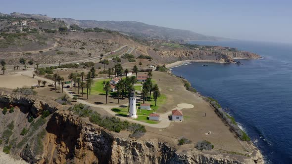 This is drone footage taken of a lighthouse on a cliff in California alt
