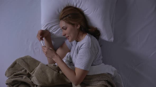 Happy Lady Lying in Bed, Holding Test and Enjoying Pleasure News About Pregnancy alt