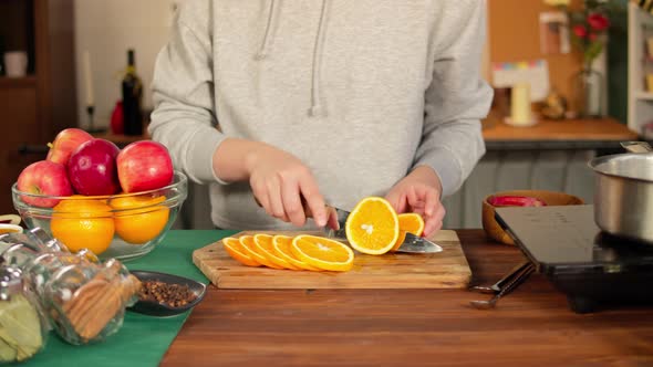 Woman Cutting Oranges for Mulled Wine alt