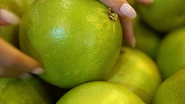 Hands Taking Green Pomelo Fruit