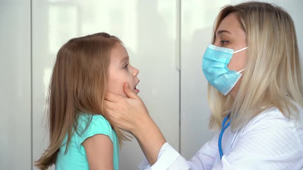 Doctor Pediatrician Examining Little Girl Patient