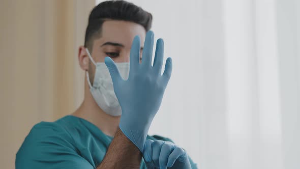 Hospital Arabian Man Worker Surgeon Wearing Hand Gloves Personal Protective Medical Mask in Interior alt