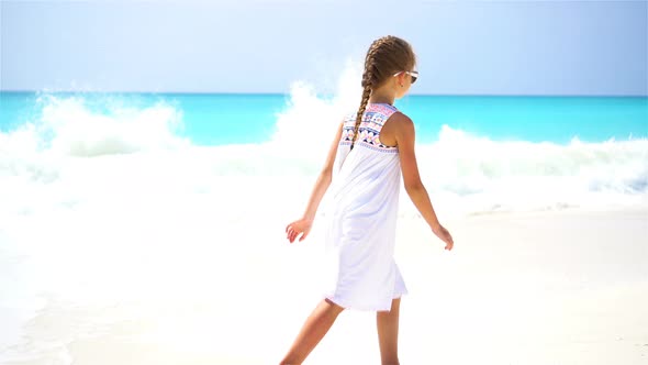 Cute Little Girl Walking at Beach During Caribbean Vacation