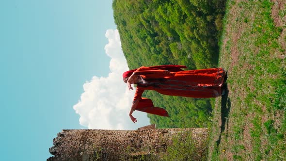 A Girl in a National Georgian Red Dress is Dancing alt