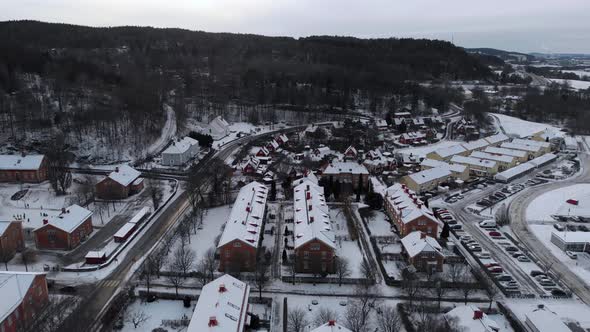 Charming Snowy Industrial Community in Sweden Residential Area Aerial Pullback