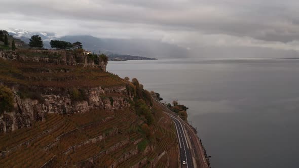 Flying over vineyards in Swiss mountains and revealing the small town Lavaux Vinorama alt