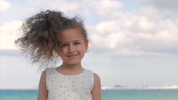 Close-up Portrait of a Beautiful Little Girl, Cute Smiling, Looking at the Camera alt