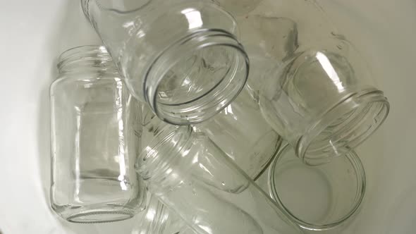 Glass packaging recycle. Empty clear glass bottles and jars alt