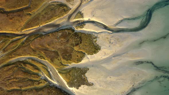 Overhead truck left view of the vein-like formations at the mouth of the Rio Blanco in the Pacific O alt