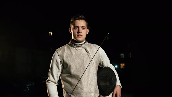 Portrait Of Young Fencer Man Looking Into Camera On The Street. alt