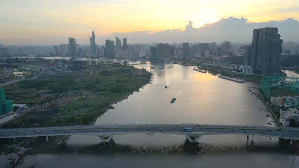 Flying at Sunset over Saigon River Bridge near Downtown of the City of Ho Chi Minh Vietnam, Boats To alt