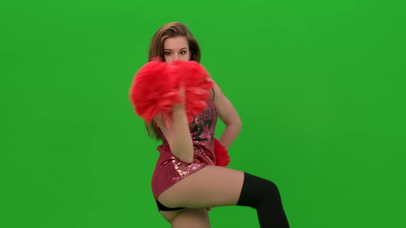 Slim Cheerleader with Long Hair Dances with Red Pompoms alt