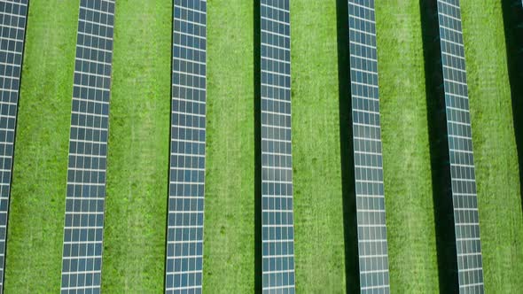 Flight Over a Solar Power Station for Production of Electricity. Vertical Straight Lines of Solar alt