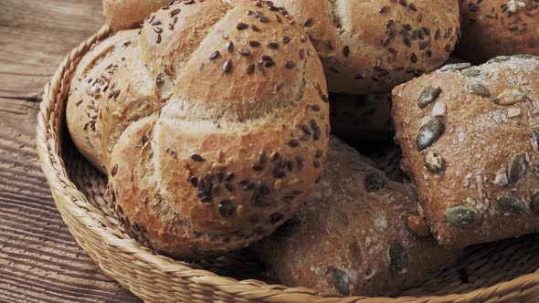 Wicker basket with selection of breads and pastries. Assortment of baked products 