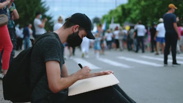 Covid19 Masked Protest Activist Man Draws Poster Sign Sitting