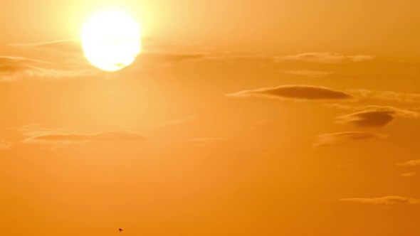 Dramatic Sunset with Sun Rays in Sky Through Orange Layered Clouds Timelapse alt
