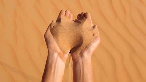 Grains of Sand Running Through Hands