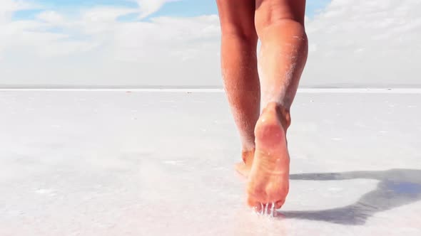 Girl Walking On White Salt Lake Surface alt
