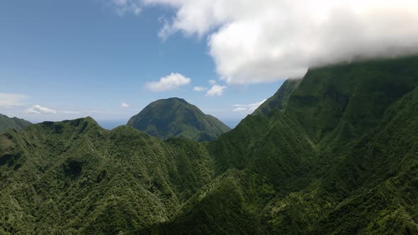 Top down aerial view of mountains, Pacific Ocean in the background, Maui, Hawaii alt
