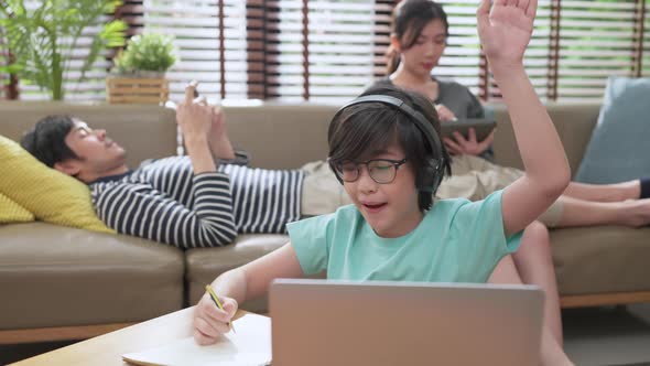 asian child hand up for answer question from online teacher online lesson study